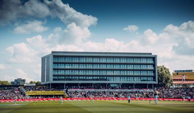 Emirates Old Trafford cricket ground with match being played and crowd